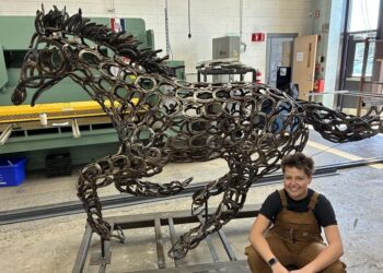 A highschool welding scholar brings a 500-horseshoe sculpture to life