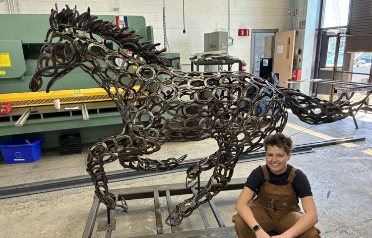 A highschool welding scholar brings a 500-horseshoe sculpture to life
